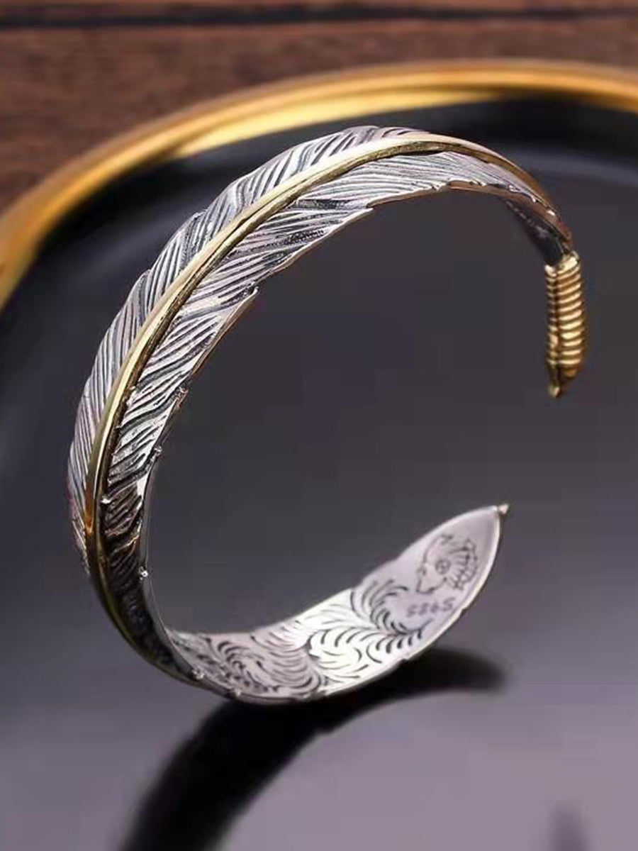 Vera Women's Cuff Bracelet featuring an intricate antique metal feather design, perfect for adding a bohemian touch to any outfit. 0