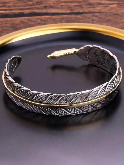 Vera Women's Cuff Bracelet featuring an intricate antique metal feather design, perfect for adding a bohemian touch to any outfit. 1
